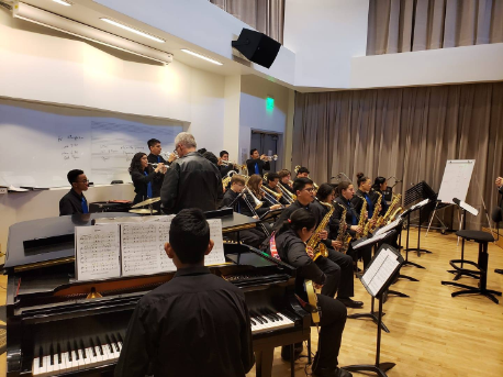 Picture of a jazz band working with David Beatty guest artist in a room at the Coil School for the Arts