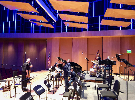 Picture of Caffey working with a band on stage Picture of Caffey working with a band on stage